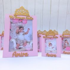 three pink and gold frames with photos of babies in them, one is holding a balloon