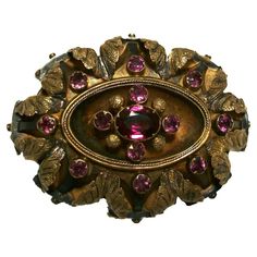 BIRKS (1879-Present) - Antique 14K yellow gold oval brooch - set with one large oval faceted purple Tourmaline (approx. .56 carats - 6.5 x 5 x 3 mm.) - surrounded by 12 small round faceted purple Tourmaline (well matched - 2 mm. diameter - approx. 0.65 carat weight total) - hand chased three dimensional leaves to the outer edge - original barrel hinge with pin - handmade safety clasp over 'C' clip - hallmarked - Canada (Montreal) - circa 1900. Excellent antique condition - all original - no loss Purple Tourmaline, Canada Montreal, Silver Baubles, Blue Valentine, Antique Pins, Barrel Hinges, Elizabeth I, Gold Brooch, Antique Brooches