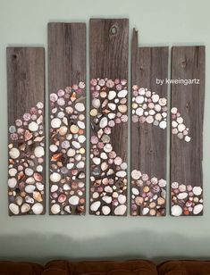 a wall hanging with seashells on it in the shape of a number six