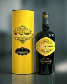 a bottle of yellow snake next to a box