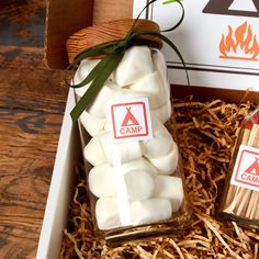 marshmallows are in a glass jar with matches