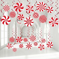 red and white candy canes hanging from the ceiling in a room with large windows