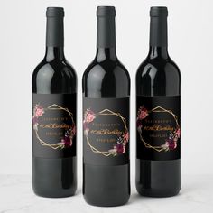 three bottles of wine sitting on top of a white countertop next to each other