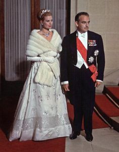 a man and woman in formal wear standing next to each other