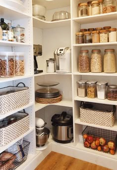 an organized pantry with lots of food in the bins and baskets on the shelves