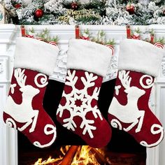 christmas stockings hanging over a fire place in front of a fireplace