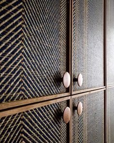 three wooden drawers with knobs on them and some wood in the bottom one is made out of woven fabric