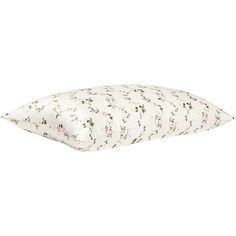 a white pillow with pink and green floral print on it, sitting on a white surface