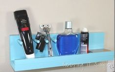 there is a blue shelf with different items on it, including a hairdryer and razor