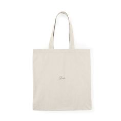 a white tote bag with the word love written in cursive writing on it