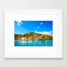 a white frame with a photo of boats on the water in front of some buildings