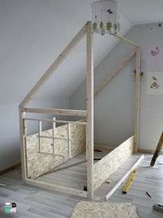 an unfinished bed frame in the corner of a room