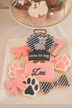 decorated cookies and pastries on a plate with the words come sit stay love written in them