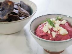 two bowls filled with food on top of a table