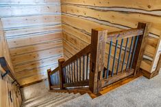 the stairs are made out of wood and have metal bars on each one handrail