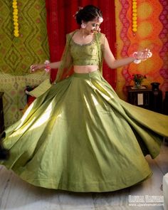 a woman in a green dress is dancing