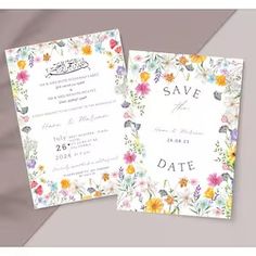 the wedding card is decorated with colorful flowers and leaves, which are printed on white paper