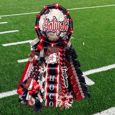 a football trophy sitting on top of a field with the name and number attached to it