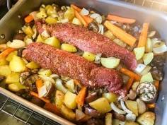 meat and vegetables in a roasting pan ready to be cooked on the stove top