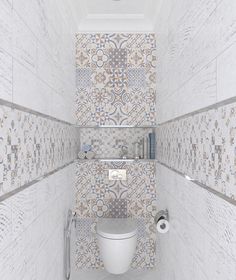 a white toilet sitting inside of a bathroom next to tiled walls and flooring on the walls