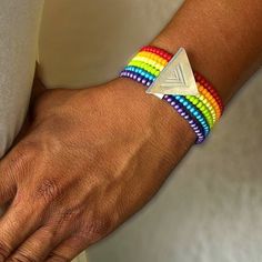 Celebrate the LGBTQ+ community with this multi-strand stretchy bright rainbow /unity bracelet.  PRIDE Jewelry / Rainbow Jewelry / rainbow bracelet / glass bead bracelet / support PRIDE / stretch bracelet / charm bracelet  Hand Strung Czech Glass Beads on elastic thread with Custom Hand Stamped Inclusion Symbol on Aluminum. 3 sizes Available Adjustable Multicolor Bracelets For Pride, Adjustable Rainbow Stretch Bracelet Spiritual, Adjustable Rainbow Stretch Bracelet, Spiritual Style, Adjustable Rainbow Spiritual Stretch Bracelet, Pride Jewelry, Pride Jewellery, Pride Bracelet, Glass Bead Bracelet, Elastic Thread