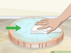 a person cleaning a table top with a cloth on it and a green arrow pointing to the