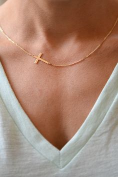 "I am obsessed with this necklace. I have been a long time fan of a classic gold cross necklace....a simple and classic daily wear. In my attempt to edge it up bit, I anchored a lovely Gold Filled Cross Pendant Sideways. The cross measures 9.5 mm by 17 mm (FYI-for reference 1 inch = 24.6 mm) and is strung on my Gold Filled Shimmer Bar Chain. So precious! Feminine and delicate, this is my go to necklace and the perfect gift. Also available with a bolder cross that measures 14.5 mm x 22.4 mm! Phot Everyday Cross Jewelry With Adjustable Chain, Adjustable Cross Jewelry For Everyday, Everyday Cross Pendant Clavicle Necklace, Minimalist Cross Chain Necklace With Delicate Chain, Minimalist Gold Chain Necklace With Cross Pendant, Everyday Clavicle Chain Necklace With Cross Pendant, Minimalist Delicate Chain Cross Necklace, Elegant Cross Necklace For Everyday, Minimalist Jewelry With Adjustable Chain And Cross Pendant