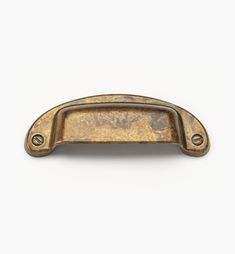 an antique brass cabinet door handle on a white background with clipping for text or image