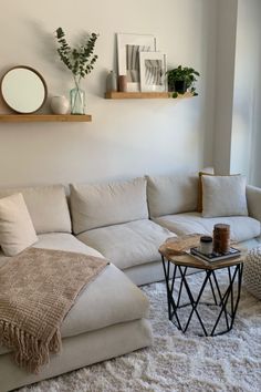 a living room with a white couch and coffee table in front of a large window