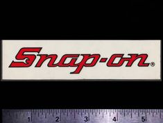 the snap - on logo is displayed in front of a measuring ruler, which has been used for several years