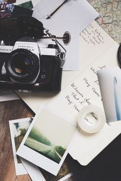 a camera and some pictures on a table