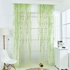 a living room with white walls and green curtains