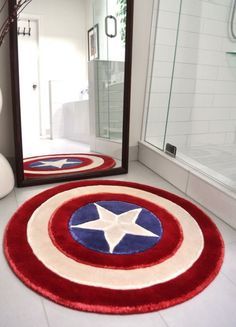 a bathroom with captain america rugs and a mirror on the floor in front of it