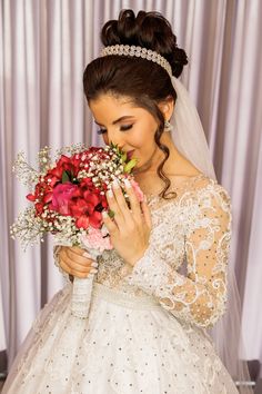 a woman in a wedding dress holding flowers