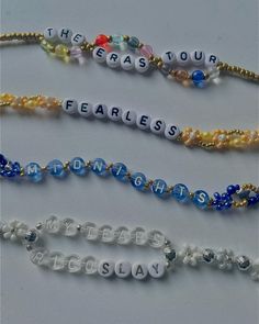 four beaded bracelets with words that spell out the word fearless on each strand