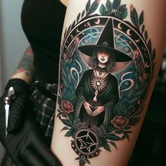 a woman wearing a witches hat and holding a pen in her right hand with roses around her arm