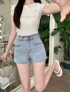 Add a touch of girly charm to your summer wardrobe with our Pretty Bow Embroidered Jean Shorts 🎀. The distressed waist and bow embroidery add a unique and cute factor to these shorts, available in four charming colors. Stay stylish and comfortable all season long. Size Chart: Size Waist (cm) Hip (cm) Length (cm) Waist (in) Hip (in) Length (in) S 60 84 30 23.62 33.07 11.81 M 64 88 31 25.20 34.65 12.20 L 68 92 32 26.77 36.22 12.60 XL 72 96 33 28.35 37.80 12.99 Description: Item Type: ShortsDecoration: Bow/Button/Embroidery/Pockets/Zipper Fabric Type: DenimPattern Type: BowsFit Type: RegularMaterial: PolyesterOrigin: CNWaist Type: HighClosure Type: Zipper Fly Cute Jean Shorts For Spring, Trendy Floral Embroidered Short Bottoms, Trendy High Waist Floral Embroidered Shorts, Trendy Short Bottoms With Floral Embroidery, Floral Embroidered Jean Shorts For Summer, Summer Floral Embroidered Jean Shorts, Casual Floral Embroidered Shorts, Floral Embroidery Jean Shorts For Summer, Cute High-waisted Shorts For Spring