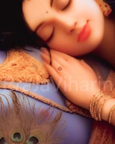 a woman laying on top of a bed with her eyes closed and hands resting on her chest