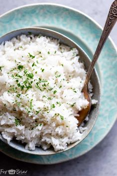 rice in a bowl with a spoon on the side