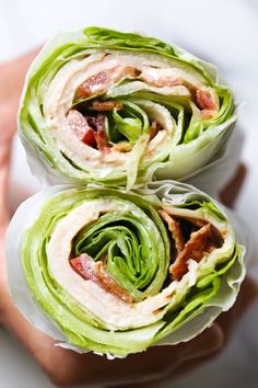 two halves of lettuce wrapped in bacon on top of each other with the wrapper pulled down