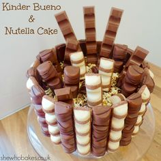 a cake that has chocolate and marshmallows on it with the words, kinder bueno & nutella cake