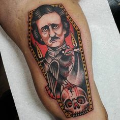 a man's leg with a tattoo on it and a skull in the middle