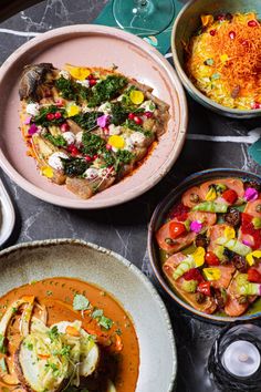 several plates and bowls of food on a table