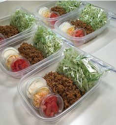 some plastic containers filled with food on top of a table