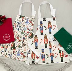 three bags with different designs on them sitting on a bed next to a red bag