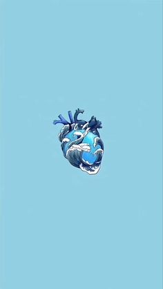 a blue heart shaped object floating in the air with two birds perched on top of it