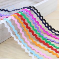 several colors of ribbon on a white background with the words $ 1 59 in front of it