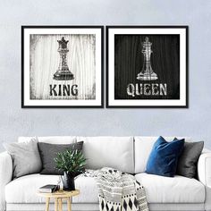 two framed pictures on the wall above a couch in a living room with a white sofa and