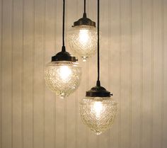 three light fixtures hanging from a ceiling