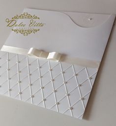 a white wedding card with bows on it